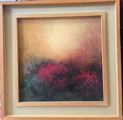 painting of a field of flowers in a wooden frame on a brick wall