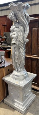 a statue of a woman holding a bird on top of a pedestal