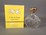 an image of a bottle of perfume next to a box of perfume