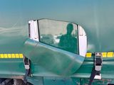 a large green truck with a yellow stripe on the side of it