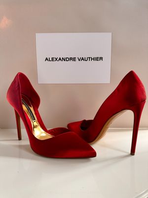 a close up of a pair of red high heels on a table