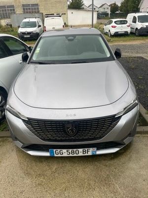 a silver car parked in a parking lot next to other cars