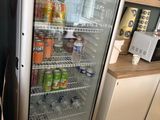 a refrigerator that has drinks in it in a kitchen