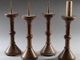 three brass candlesticks sitting on top of each other on a table