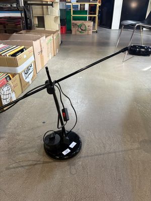 a black lamp that is on the floor in a room