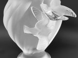 black and white photograph of a vase with a bird on it