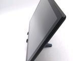 a tablet computer sitting on a stand on a white surface