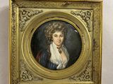 portrait d'une femme en robe bleue dans un cadre doré