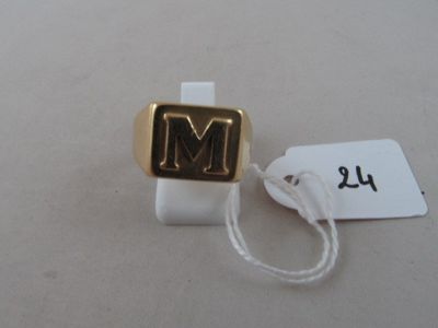 an image of a gold ring with the letter m on it