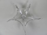 underside view of a clear glass candle holder on a white surface