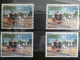 four stamps with a picture of a horse drawn carriage on them