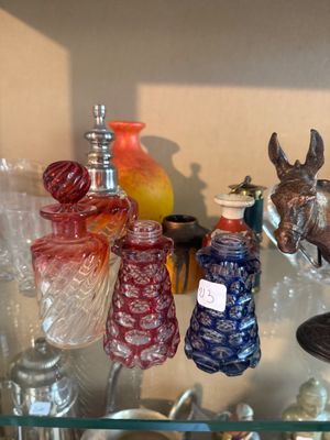 a glass shelf filled with glass vases and other glass items