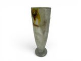 a glass vase with a bird on it on a white background