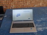 two laptops sitting on a table next to each other