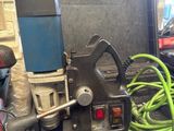 a tool that is sitting in a case with a green hose
