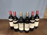 six bottles of wine are lined up on a wooden table