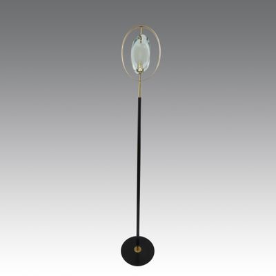 a black and gold floor lamp with a glass globe on top