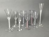 six wine glasses and a wine glass on the table