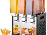 four drinks being served in a dispenser on a table