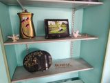 a shelf that has a clock and a picture on it