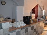 a counter with a bunch of cups and bowls on it