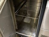 stainless steel counter top with open door in a commercial kitchen