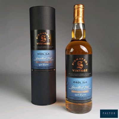 two bottles of whisky sitting next to each other on a table