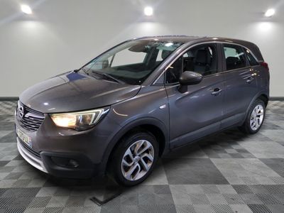 the grey car is parked on a checkered floor in the garage