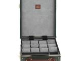 an open suitcase with a bunch of watches inside of it