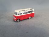 a red and white toy bus on a gray surface