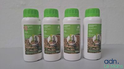 four bottles of horse feed sitting on a table next to each other