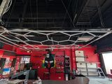 a room with a red wall and a ceiling that has a lot of art on it