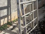 a ladder leaning up against a wall next to a building