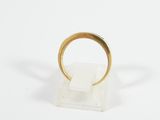 a close up of a gold ring on a white surface