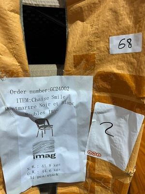 a piece of paper taped to the back of a chair