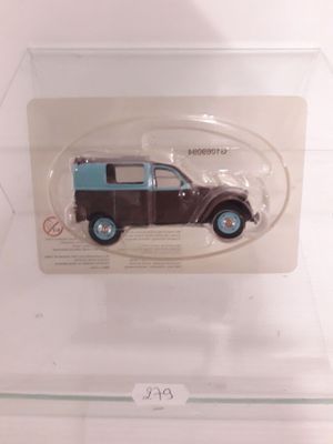 a brown and blue toy car in a clear display case