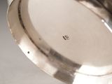 a close up of a silver plate with a number on it