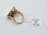 a close up of a gold ring with a diamond on it