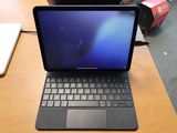 a laptop that is sitting on a desk with a keyboard