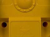 a close up of a yellow toy robot on a blue surface