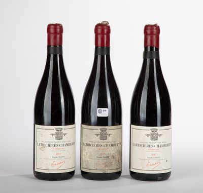 trois bouteilles de vin sont alignées sur une table