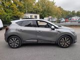 a silver car that is parked on the side of the road