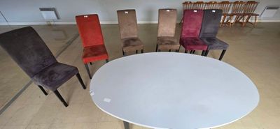many chairs around a white table in a room