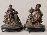 pair of antique bronze figurines of a woman and a man