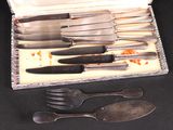 a silver tray with silverware in it on a table