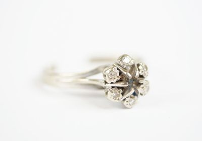 an image of a diamond flower ring on a white background