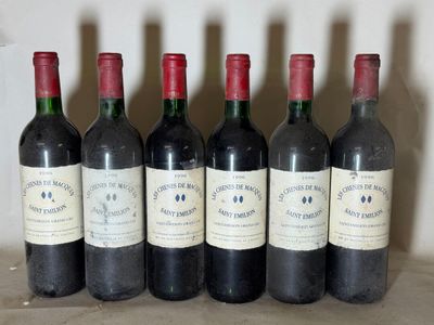 six bottles of wine are lined up in a row on a table