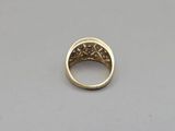 a close up of a gold ring on a white surface