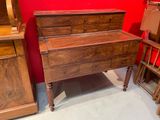 an image of a wooden dresser in a room with red walls
