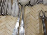 a lot of silver spoons and spoon spoons on a plate